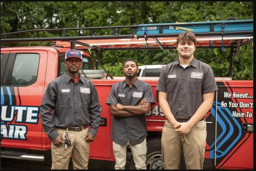 Absolute Best Air team members beside a branded service truck
