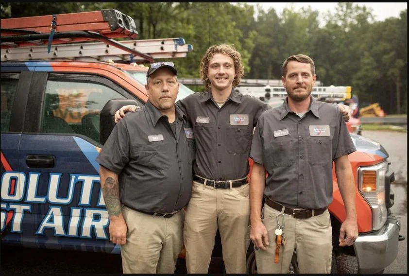Absolute Best Air team members with a service vehicle