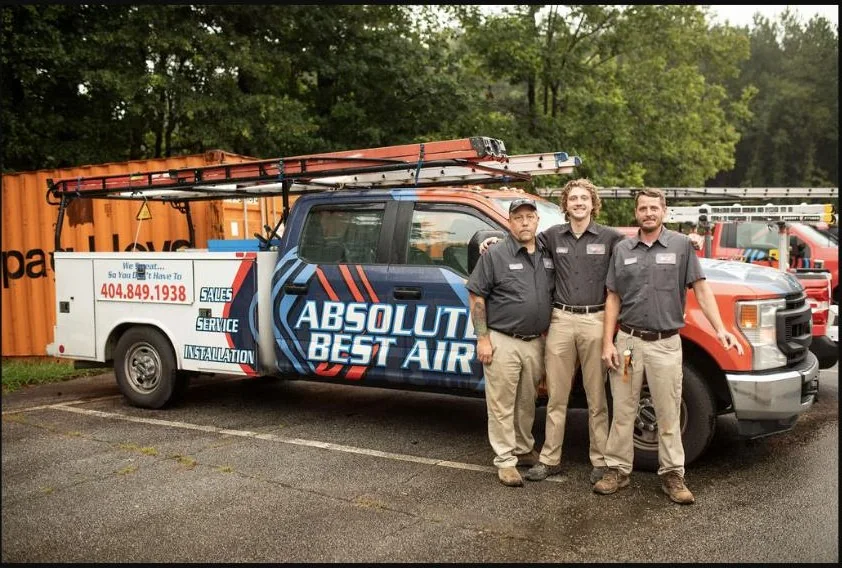 Absolute Best Air team members beside a branded service truck